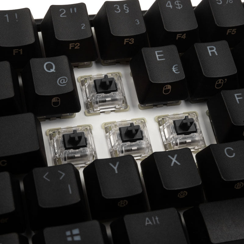 Ducky Mecha Mini gamingtastatur MX-Black RGB 60 % svart montert på skrivebord